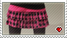 A female wearing a black shirt, pink and black checker skirt and black leggings
